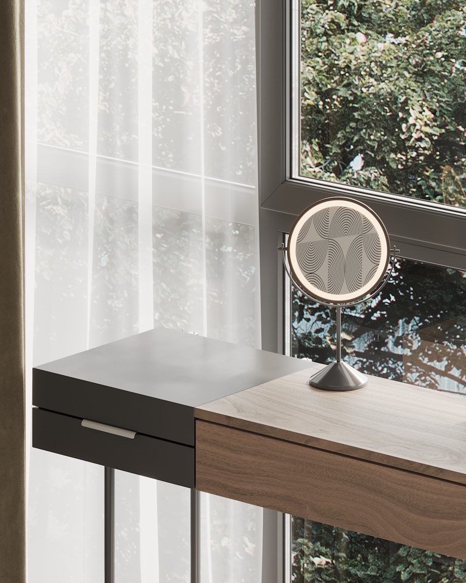A table with a mirror on it next to a window